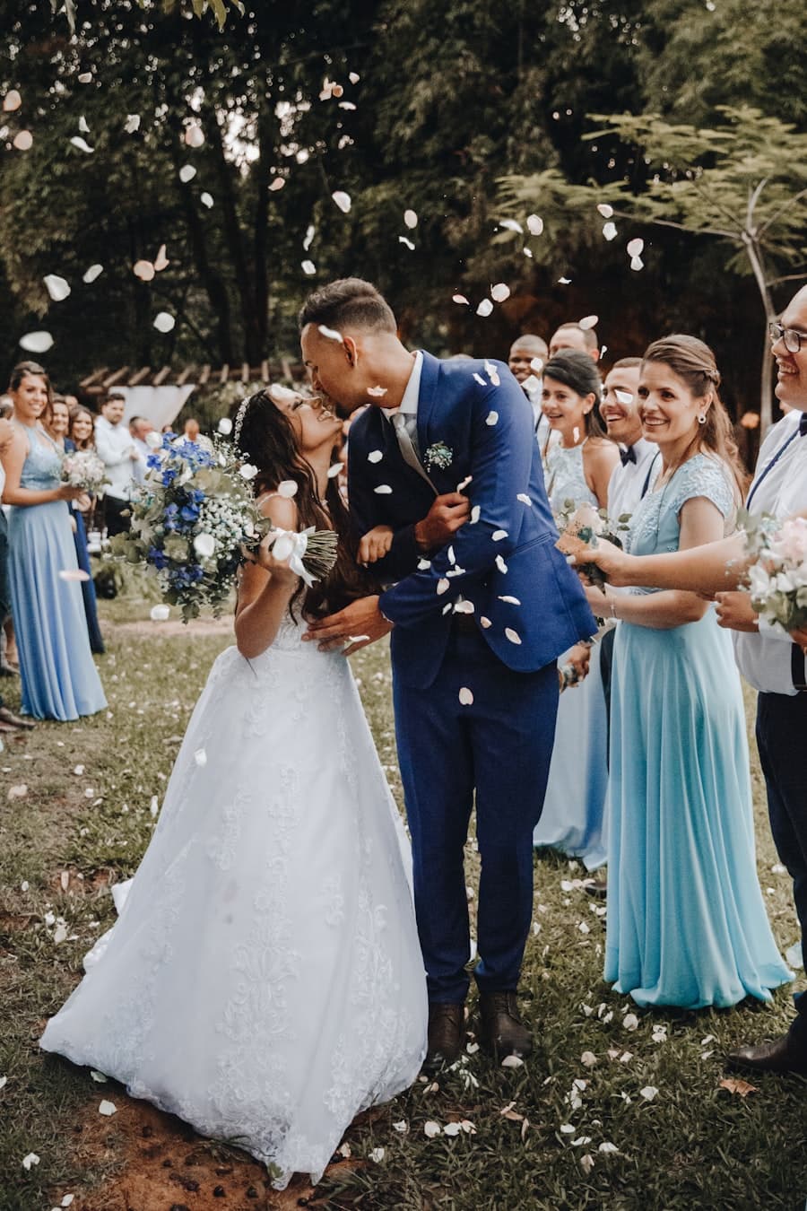The couple, half-hidden by confetti and friends